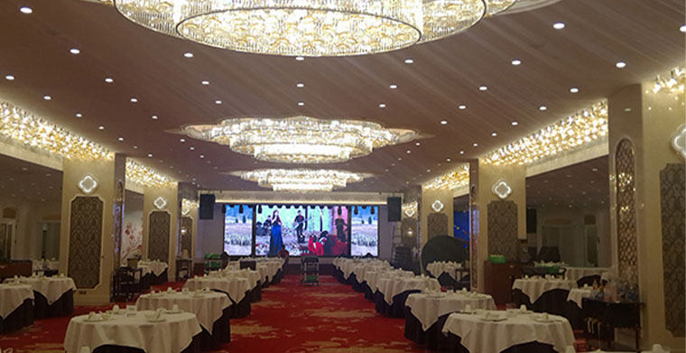 Do I need to rent stage audio separately for the wedding in the hotel banquet hall?